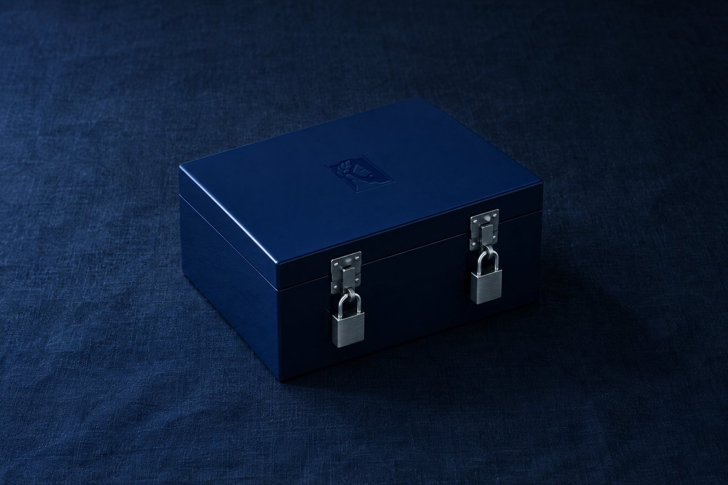 A navy lacquered box closed with two steel padlocks, the Olivent mark pressed into the lid